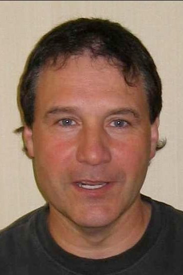 John W. Iwanonkiw - Gotham Police Officer / Fan (uncredited)